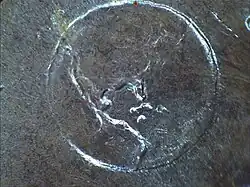 Détail d'une pièce de monnaie représentant la Terre.