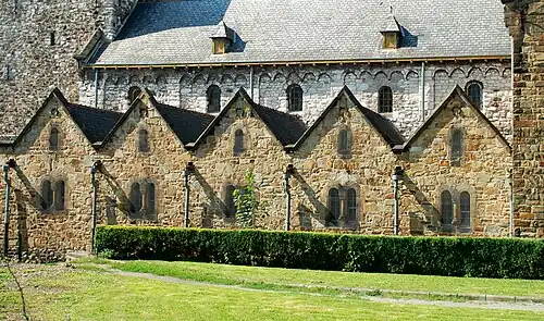 Le mur de la nef romane (en moellons gris)et les chapelles latérales néo-romanes (en moellons bruns).