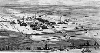 Gravure en noir et blanc du dix-neuvième siècle montrant une usine située dans un espace rural plat.
