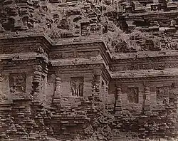 : Close view of temple façade showing detail of mouldings and sculpture niches