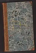 Un livre de la bibliothèque de Badin, avec son nom en lettres dorées sur la couverture.