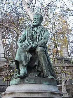 Edmond About (1887), statue ornant la sépulture de l'écrivain, Paris, cimetière du Père-Lachaise.