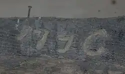 La date 1796 gravée dans le bois de la croix.