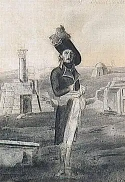 Gravure en noir et blanc : homme en pied, en uniforme impérial au milieu de ruines antiques