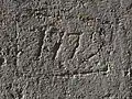 Date (1779) gravée sur le mur extérieur de l'église Saint-Pierre de Granchain (face Nord)