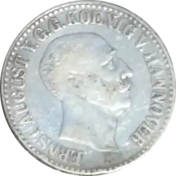 Portrait d'un homme sur une pièce de monnaie.