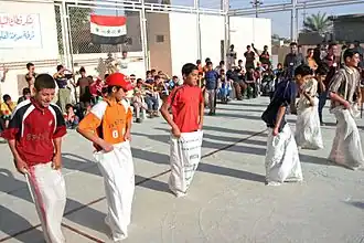 Groupe d'enfants participant à une course en sac, à Falloujah en Irak, en 2008.
