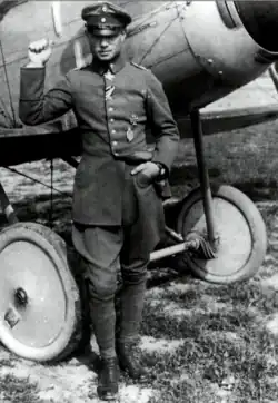 Photo noir et blanc d'un homme adossé à un avion.