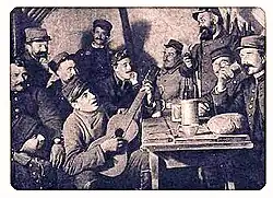 Le soir, dans l'abri de la tranchée, vin et musique.