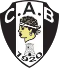 Blason noir et blanc avec une tête de Maure, symbole de la Corse. En dessous figurent une tour et la date 1920.
