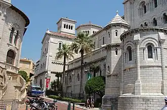 Façade est et abside en arrière plan avec une partie de la façade du palais de justice (à gauche).