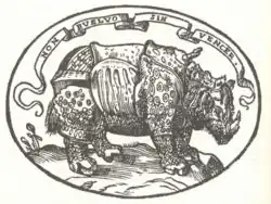 Dans l'emblème, le rhinocéros de Dürer est surmonté d'une légende « Non buelvo sin vencer », « Je ne reviendrai pas sans victoire ».