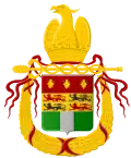 blason incorporant un drapeau vert et blanc ceint par une couronne jaune et des rubans rouges et surmonté par un aigle