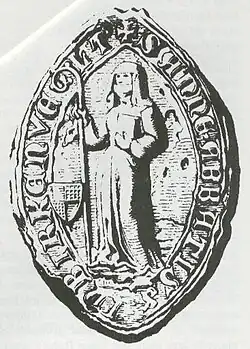 Photographie d'un sceau sur lequel est représenté une religieuse tenant une crosse.