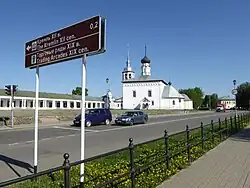 Photographie d'un panneau bilingue marron anglais russe indiquant le kremlin et les galeries commerciales.