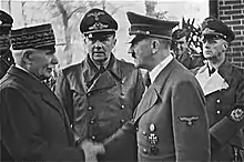 Poignée de main entre Philippe Pétain et Adolf Hitler marquant la collaboration entre le régime de Vichy et l'Allemagne nazie.
