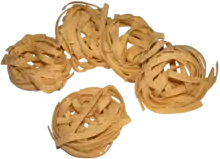 Photographie sur fond blanc de pates en rouleaux.