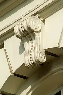 Clé d'arcà perles et volutes.