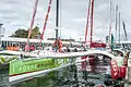 Le trimaran aux côtés des autres voiliers de la flotte sous le regard du public du village départ de la Route du Rhum