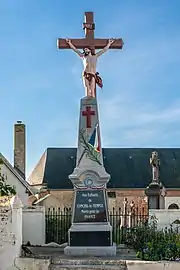 Le monument aux morts devant un calvaire.