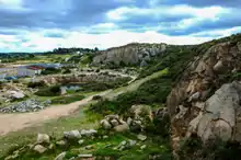 Carrière de granite à l'abandon. Un étang s'est formé dans une dépression artificielle.