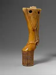 Pied de meuble en forme de jambe de taureau ; 2960-2770 avant J.-C. ; ivoire d'hippopotame ; hauteur : 17&nbsp;cm, largeur : 3,4&nbsp;cm, profondeur : 5,8&nbsp;cm ; Metropolitan Museum of Art.