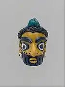 Tête d'homme barbu, pendentif, IVe&nbsp;– IIIe&nbsp;siècle av. J.-C., production carthaginoise. Metropolitan Museum.