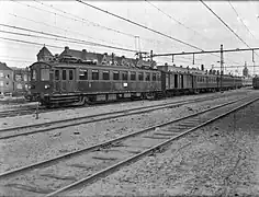 Composition avec un fourgon en bois à essieux (1946).