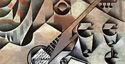 Juan Gris, 1912, La Guitare (Guitare et Lunettes), huile sur toile, 30&nbsp;×&nbsp;58&nbsp;cm, collection privée. Exposició d'Art Cubista, Barcelone, 1912