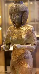 Statue H. 59 cm. Bronze incrusté d'or et d'électrumXXIIe dyn. v. 860. Haute-ÉgypteLouvre