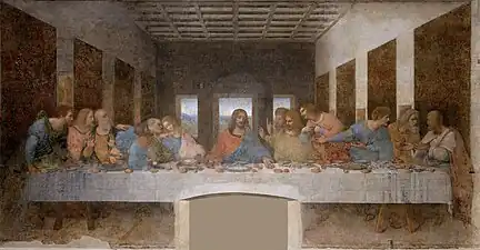 Image d'une peinture montrant au premier plan, à l'intérieur d'une salle à plafond à caissons, une longue table de dîner avec au centre la figure isolée du Christ, les bras tendus en forme presque pyramidale entouré par les apôtres. La salle est éclairée par trois fenêtres à l'arrière et par un éclairage frontal depuis la gauche.