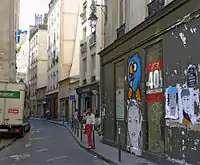 La rue Geoffroy-l'Angevin vue depuis celle du Temple ; en arrière-plan, on aperçoit, en bleu, les parties hautes du centre Beaubourg.