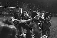 Joueurs stéphanois se congratulant après un but. Au fond de l'image, le but.