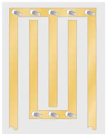 A stripline circuit consisting of a number of long parallel vertical lines. There are two horizontal lines with numerous short-circuit straps fed through holes to the board's ground plane. The vertical lines are alternately connected to the top and bottom horizontal lines. The free end of the first and last horizontal lines form the input and output respectively.