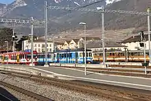 Des rames AOMC, ASD et AL dans leurs anciennes livrées en gare d'Aigle en 2010.