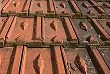 Tuiles à emboîtement avec un dessin en forme de losange.