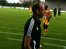 Yann Lachuer sur la touche d’un terrain de football.